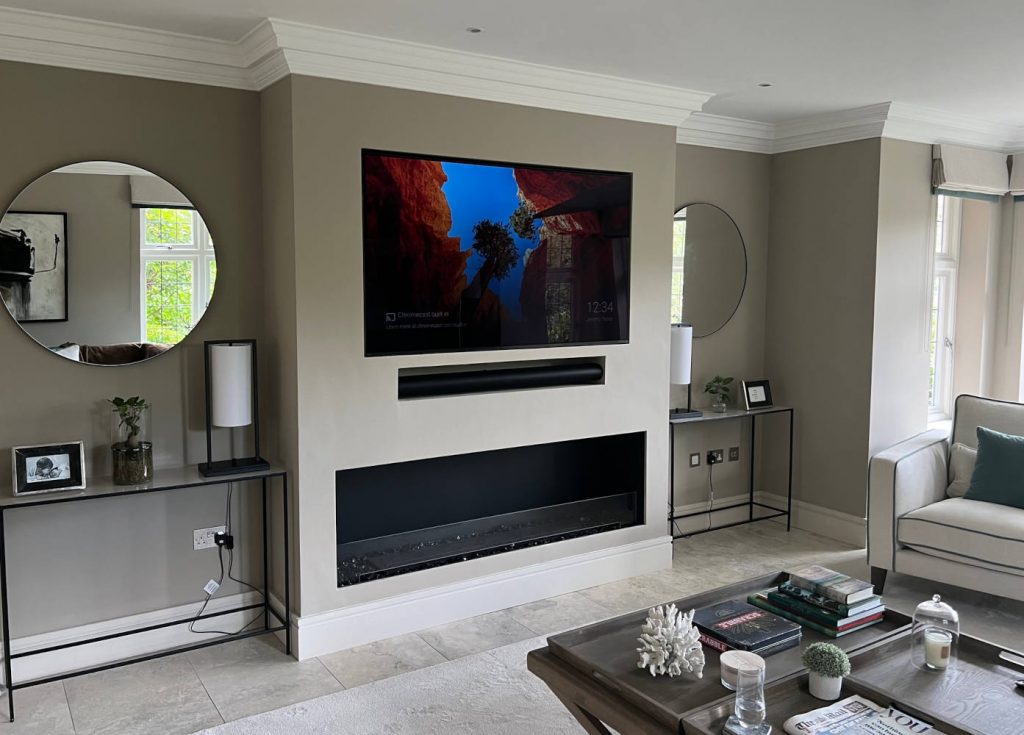 Completed media wall installation London with TV recess, shelves and modern finish